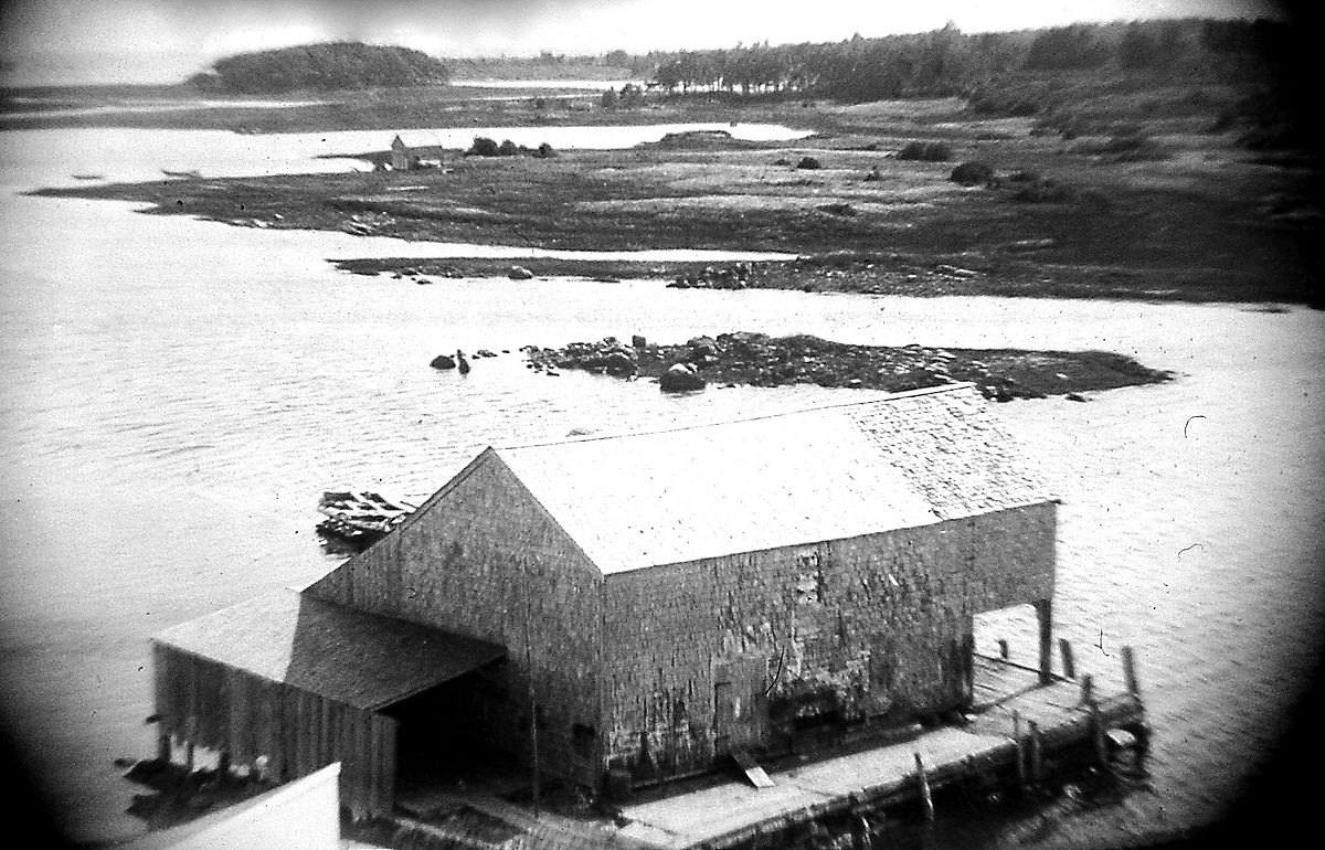 The Clement Huff boat house and wharf at the end of what is now the Langsford Road, Vaughn’s Island is in the distance.