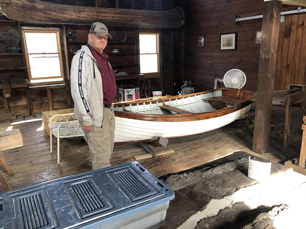 Harrison Small showing off his grandfather’s work in the boathouse