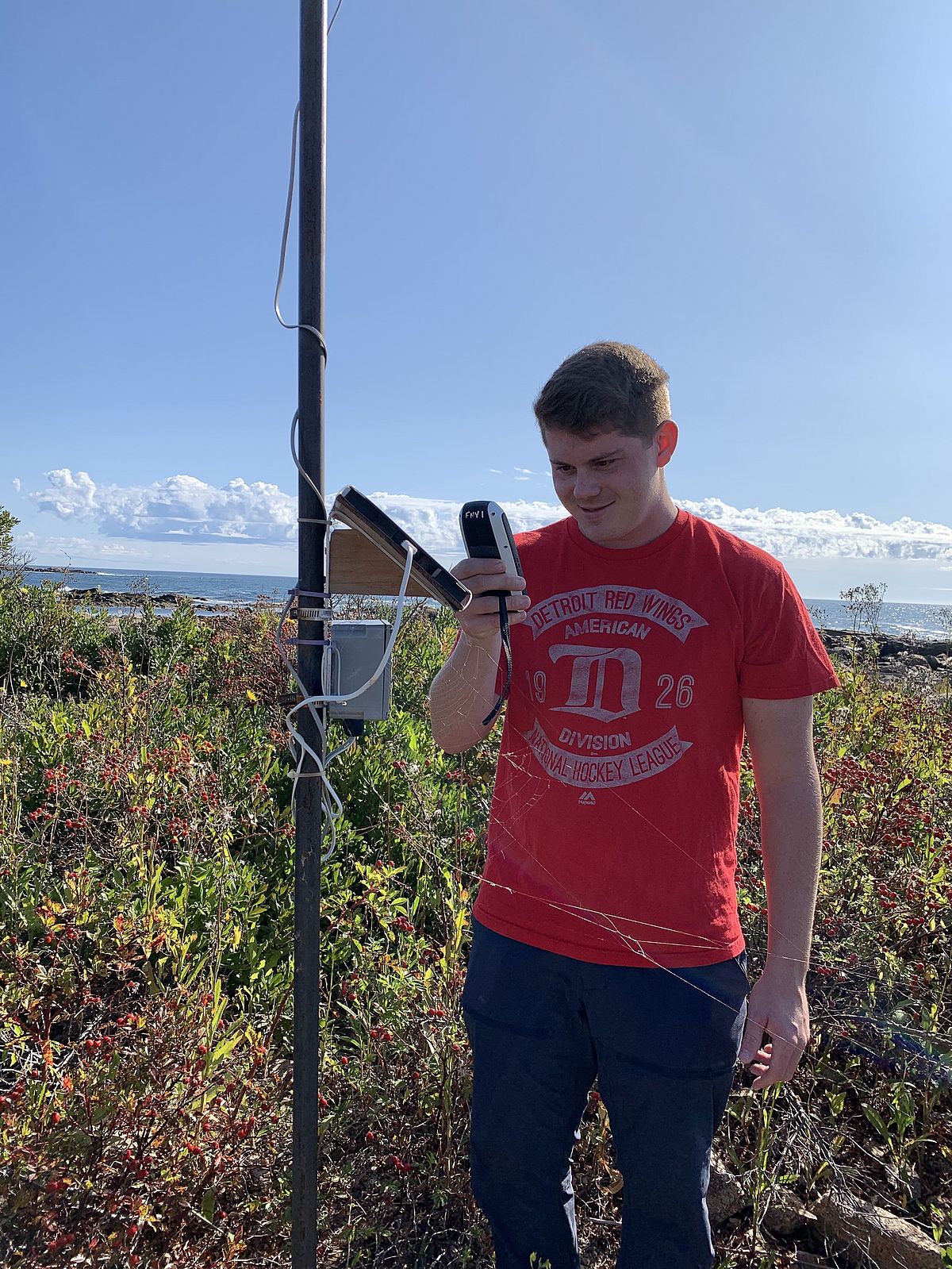 UNE student collecting wind data on Goat Island