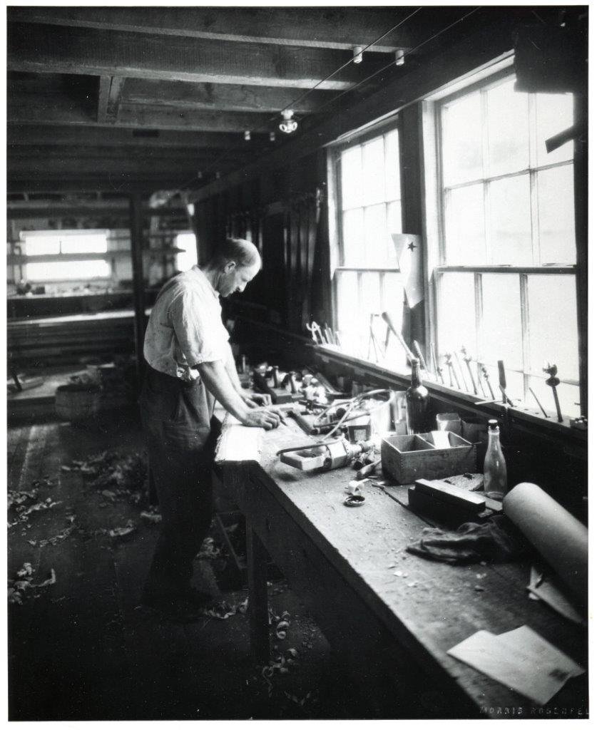 Clem Clark working in his boathouse
